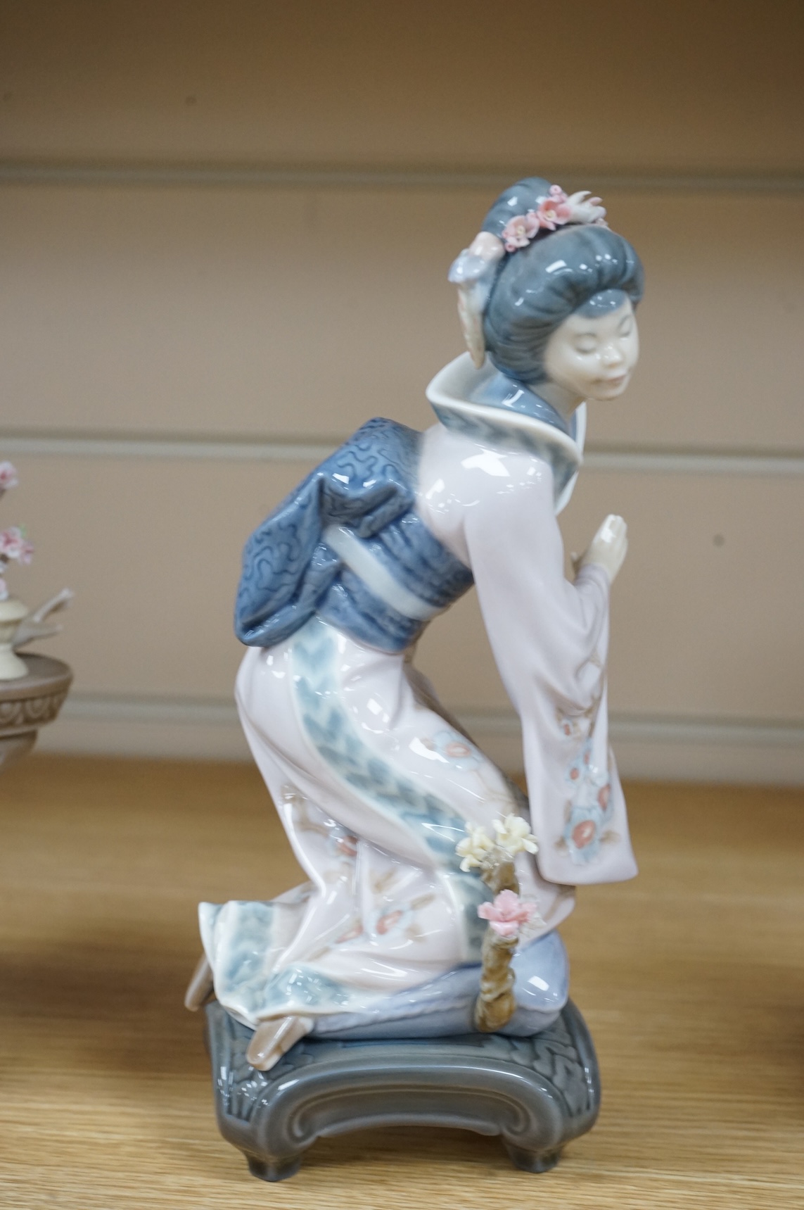 Three Lladro models of seated Geisha. Tallest 23cm